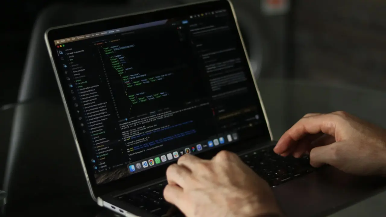 Developer coding on a laptop
